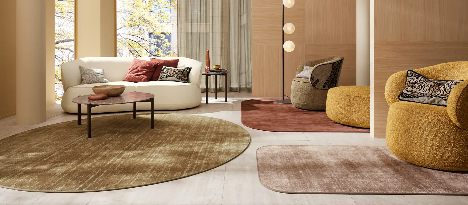 Living room layered with round rugs in ochre and terracotta